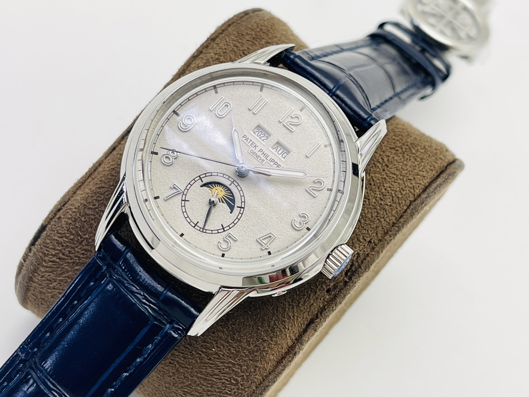 Silver-tone watch on suede cushion with textured dial and date window