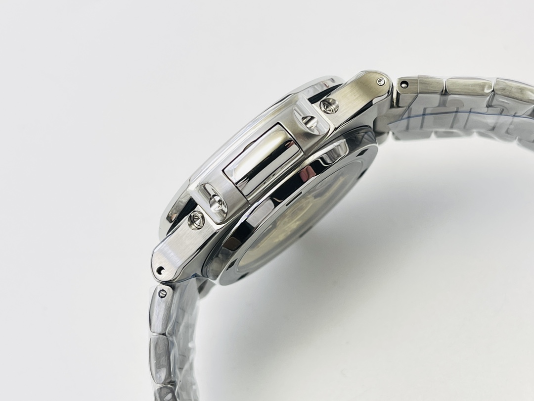 Side profile of stainless steel watch case showing crown, pushers, and bracelet links
