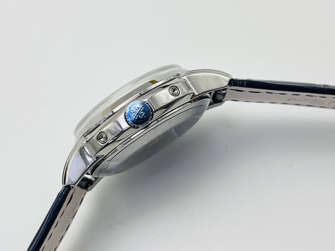 Side view of watch with blue crown and polished case detail