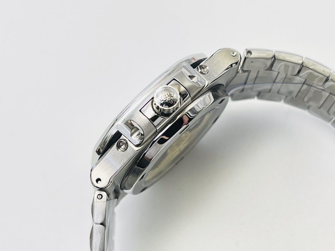 Close-up of watch crown with logo and polished steel case detailing
