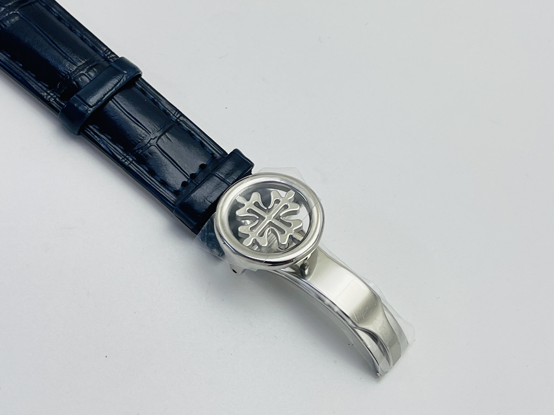 Folded clasp detail with engraved logo on blue leather strap