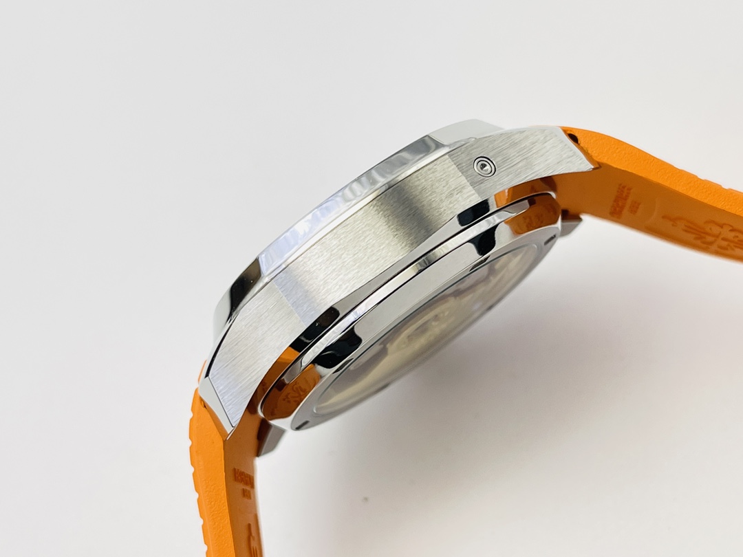 Side profile of a stainless steel watch case with orange strap.