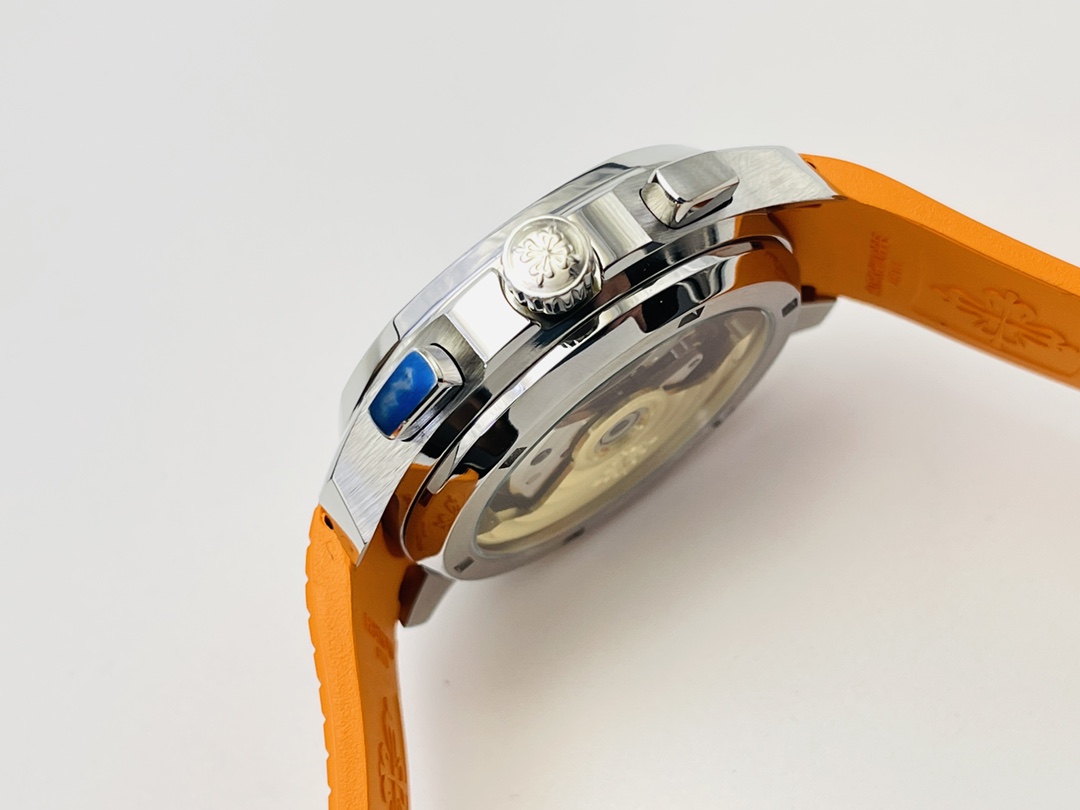 Case side detail showing crown and pushers on a luxury watch with orange strap.