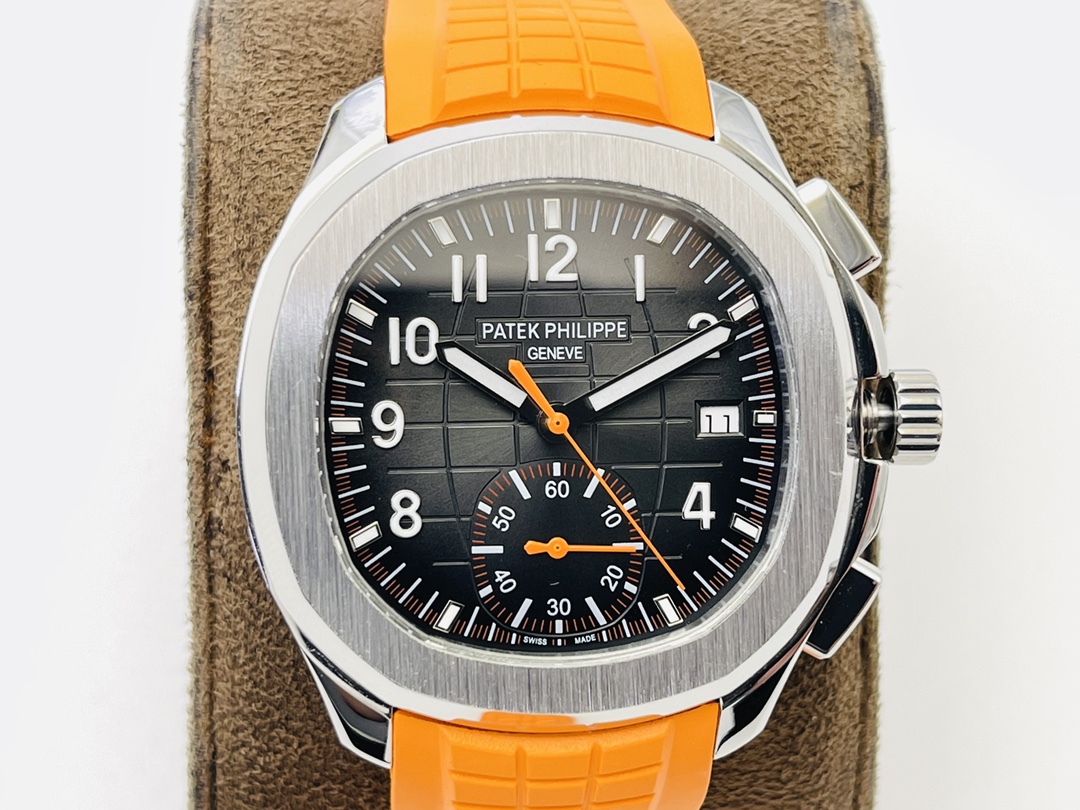 Detailed dial view of a Patek Philippe watch with orange accents and rubber strap.