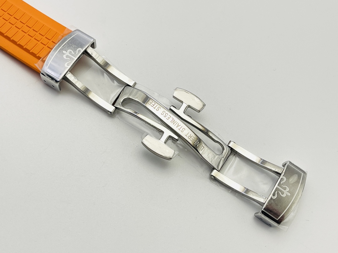 Open deployant clasp detail in stainless steel attached to an orange strap.