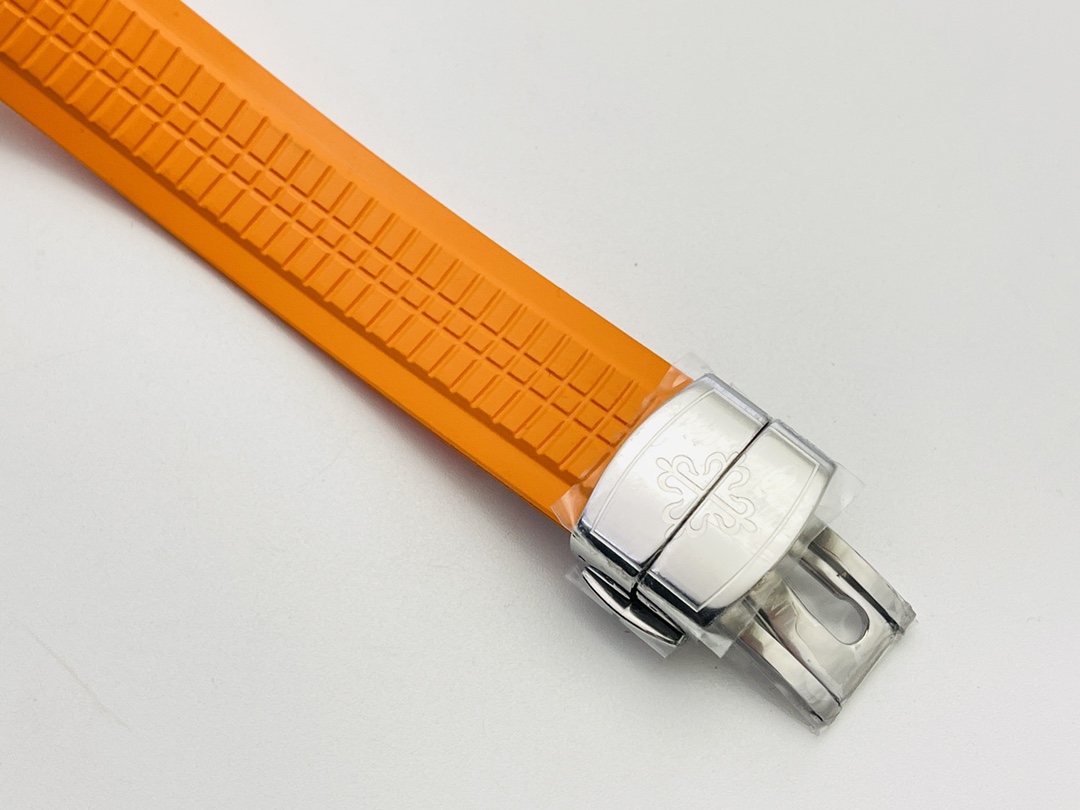 Orange rubber watch strap with stainless steel deployment clasp.