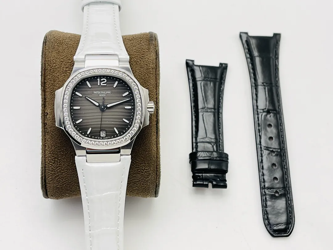 Patek Philippe Nautilus 7118 ladies watch with grey wave dial, diamond bezel, white leather strap, and black spare strap.
