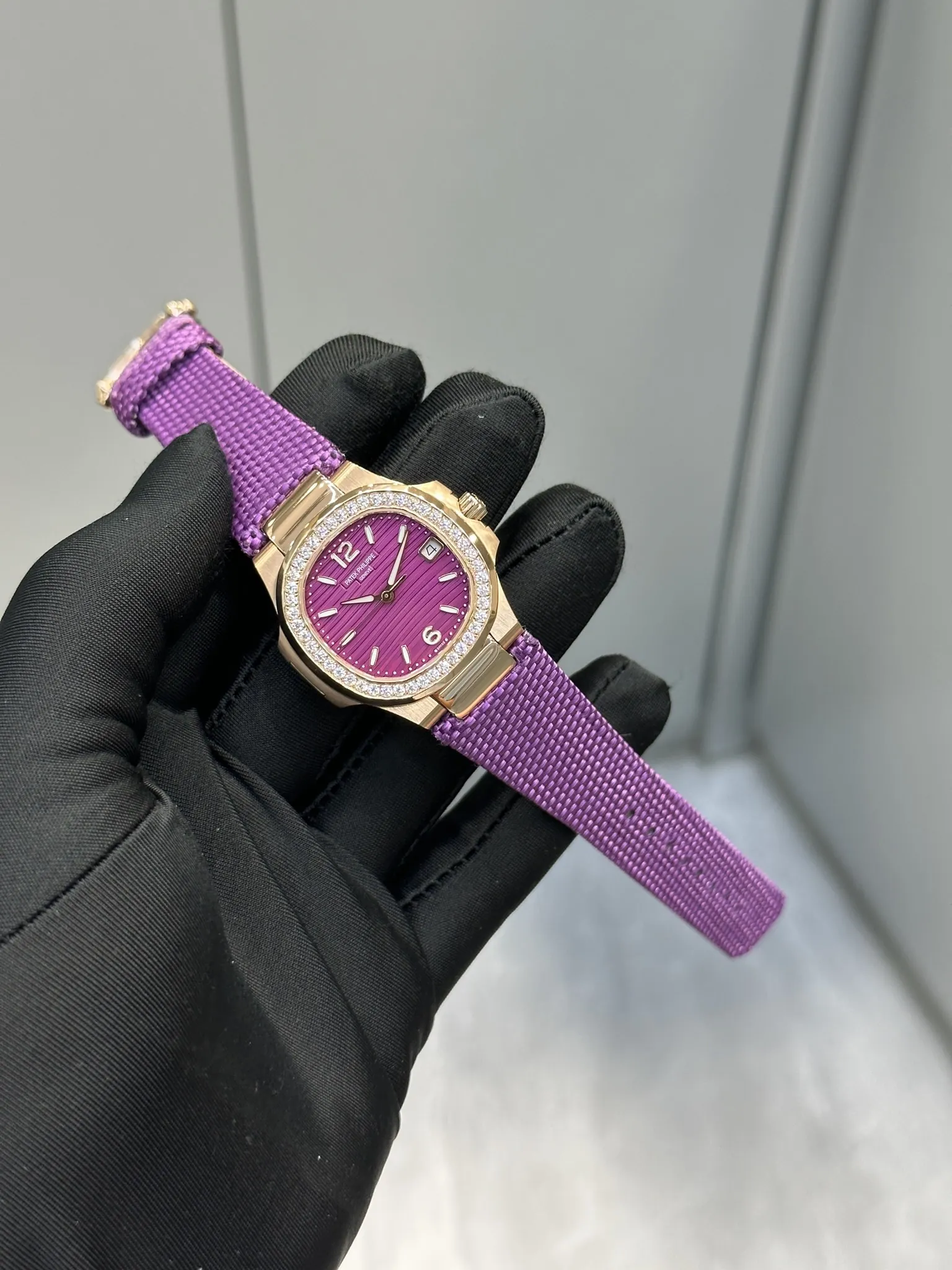 Super Clone Patek Philippe Nautilus 7010R-013 Replica 32mm Purple Wave Dial Diamond Bezel Purple Woven Strap Ladies Watch Side Profile Of The Dial